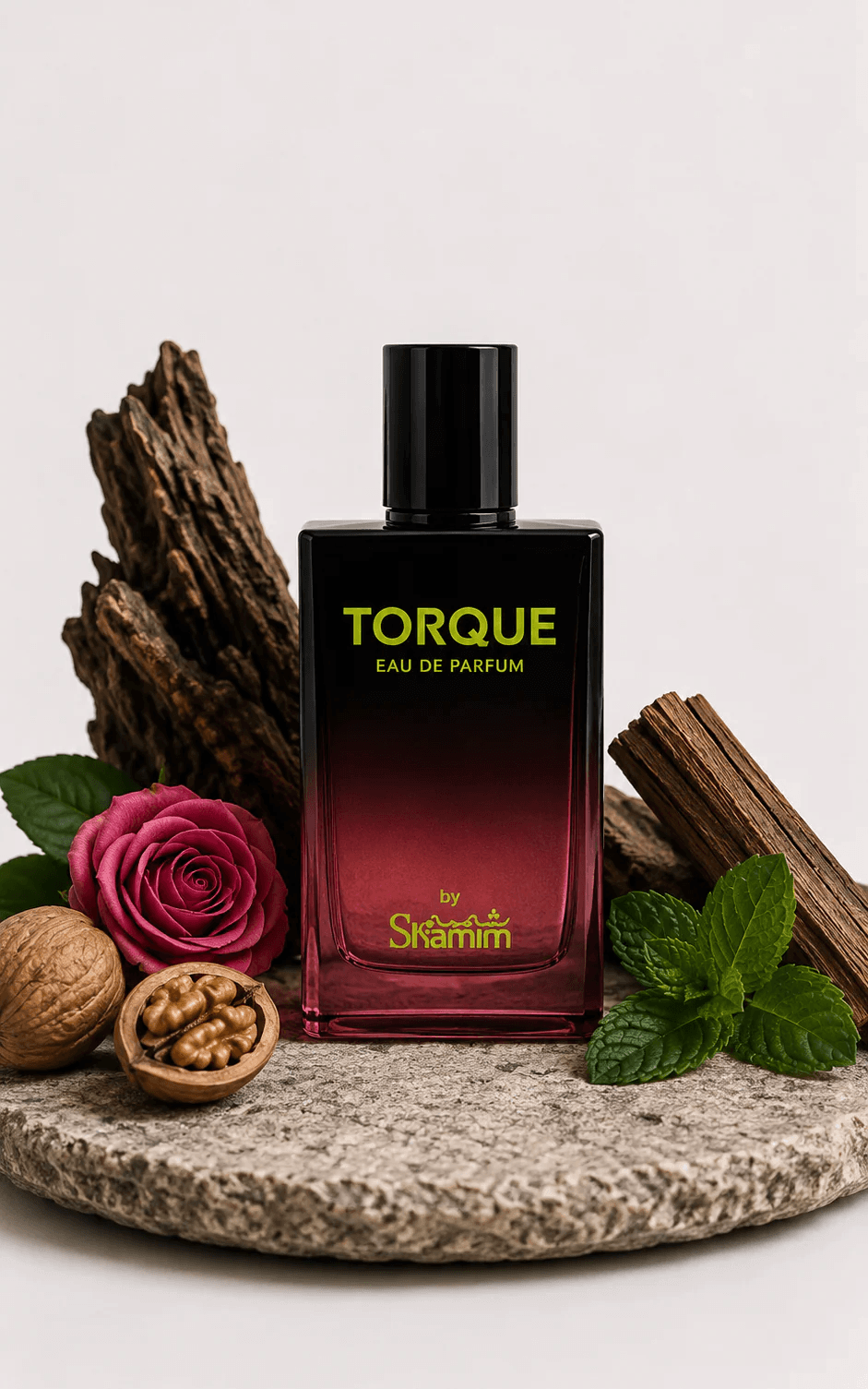 A bottle of Torque Eau de Parfum by Skaramell, featuring a black-to-deep-red gradient glass bottle with gold lettering, styled on a stone plate with a rose, walnuts, cinnamon, and mint leaves against a light gray background.