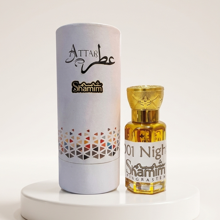 Shamim Attar 101 Night Shams al-Aqsa perfume bottle with a gold cap next to its white cylindrical packaging box, displayed on a white round pedestal.